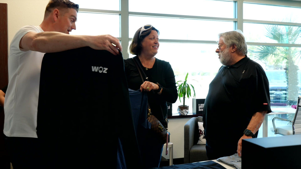 Tom Carter with Steve Wozniak holding WOZ branded merch